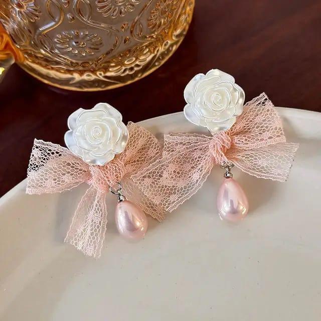 Elegant rose pearl drop earrings with white resin rose, pink lace bow, and blush teardrop pearl charm.
