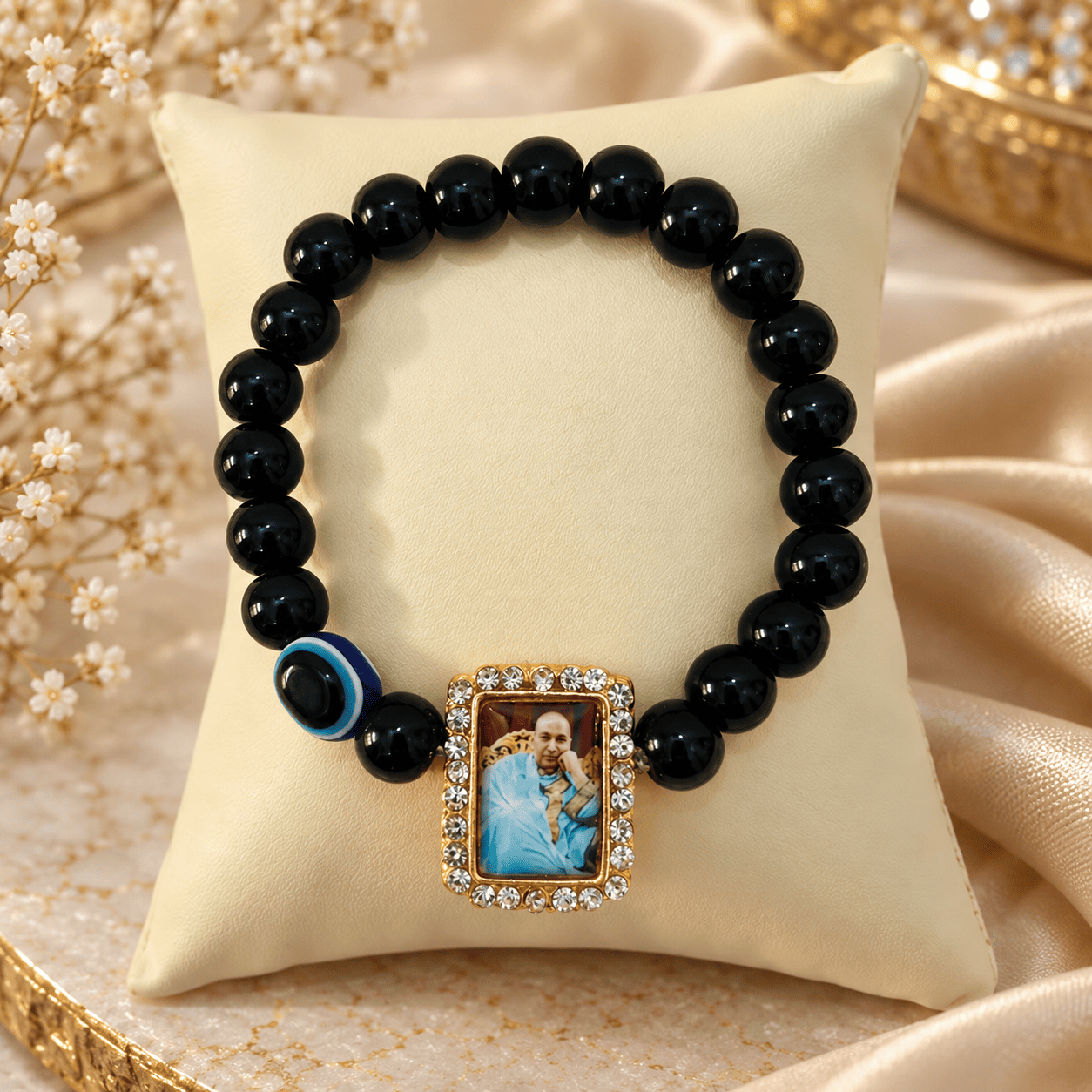 Home | Grab n Gift Guruji Blessings Bracelet with glossy black beads, blue accent and rectangular Guruji photo charm