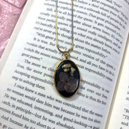 Oval Black Resin Pendant with Floral Accent