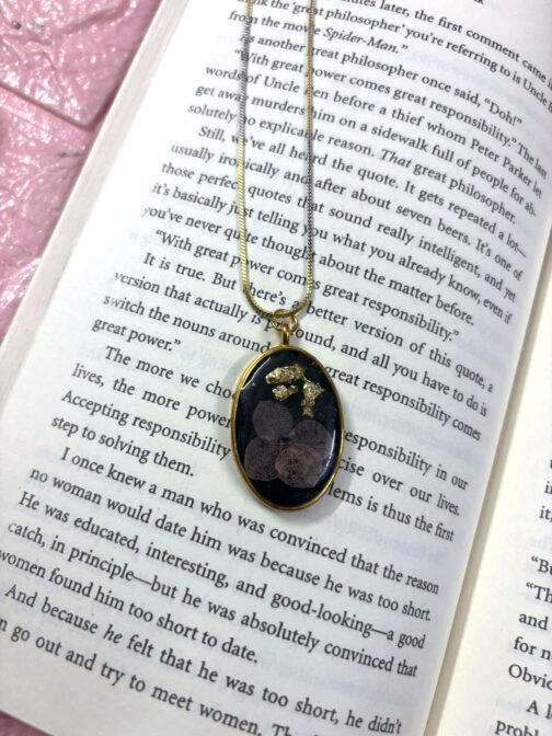 Oval Black Resin Pendant with Floral Accent