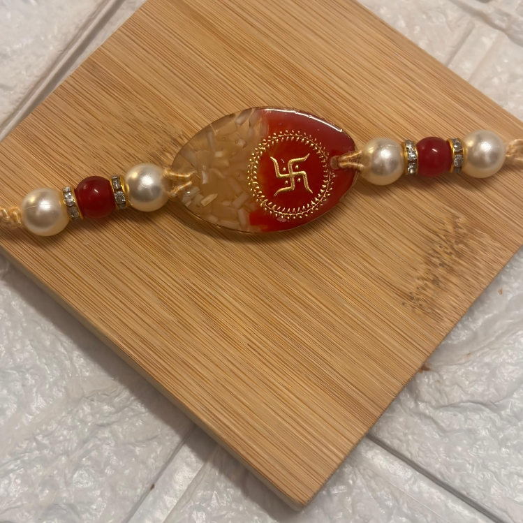 roli chawal resin rakhi with Swastik