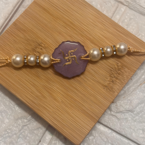 resin rakhi with golden Swastik